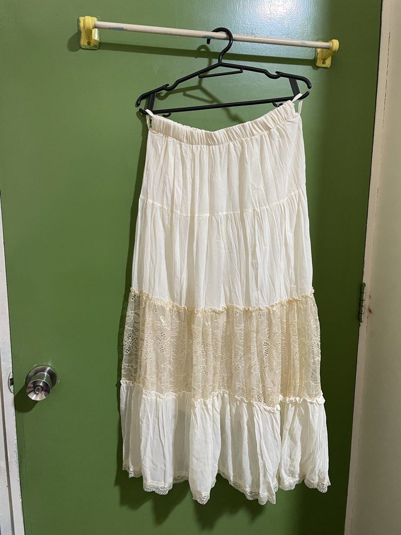 White tiered maxi skirt with lace insert (Category: Skirts) located in Binan City. Submitted by pompompuurins (Listing ID 1465815461, Image 1). Description: - Color: White with cream floral lace detail - Style: Tiered long skirt with elastic waistband - Fabric: Lightweight and breathable, ideal for warm weather - Fit: Midi to maxi length (varies by height) - Condition: Brand new / Excellent (ready to wear).