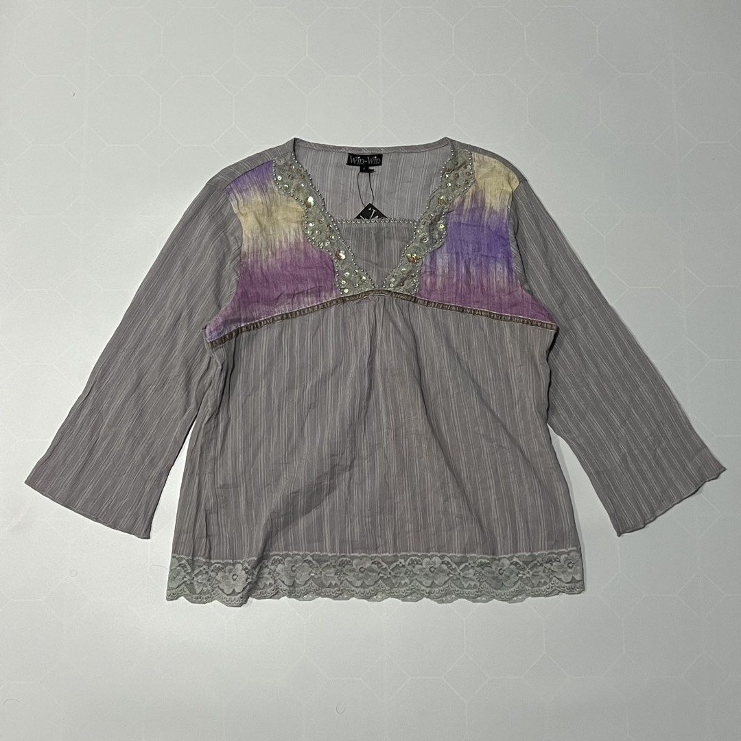 Win-Win Grey Purple Beaded Neck Top Blouse (Category: Blouses) located in Caloocan City. Submitted by lostarchive_55 (Listing ID 1465915306, Image 1). Description: - Brand: Win-Win (Original tag still attached) - Color/Pattern: Grey with striped texture and purple/yellow watercolor shoulder panels - Neckline: V-neck with ornate lace, bead, and sequin detailing - Sleeves: 3/4 sleeves - Hem: Matching lace border finish - Condition: Brand new, never