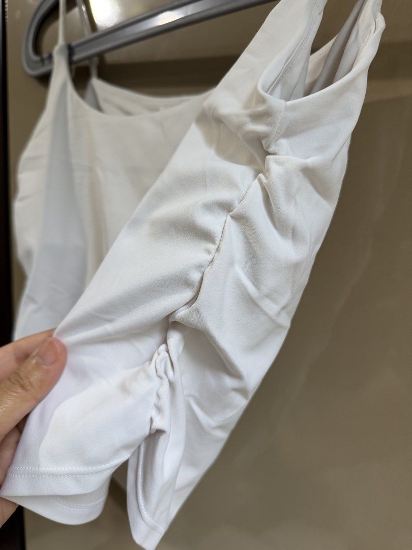 Workout Cami Crop Top with Ruched Sides (Category: Sleeveless) located in Pasay City. Submitted by closetbykim (Listing ID 1465786213, Image 2). Description: White cami top with thin straps and a straight neckline. Unique ruched gathering along the sides adds texture. Cropped length, soft stretch fabric. Minimalist style, easy to pair with high-waisted jeans or skirts. Clean and crisp colour. Great basic piece for casual everyday wear or layering