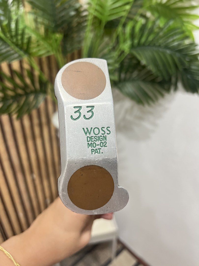 Woss Design MO-02 Putter (Category: Golf) located in Manila. Submitted by livefish.26c802 (Listing ID 1465879529, Image 1). Description: Woss Design MO-02 golf putter. Made in Japan. Classic mallet style head with distinct alignment markings on the sole. Original black Woss grip attached. Shaft includes the original branding sticker. Standard steel shaft in good shape. Clubhead shows normal wear from previous rounds on the course. Ready for the n