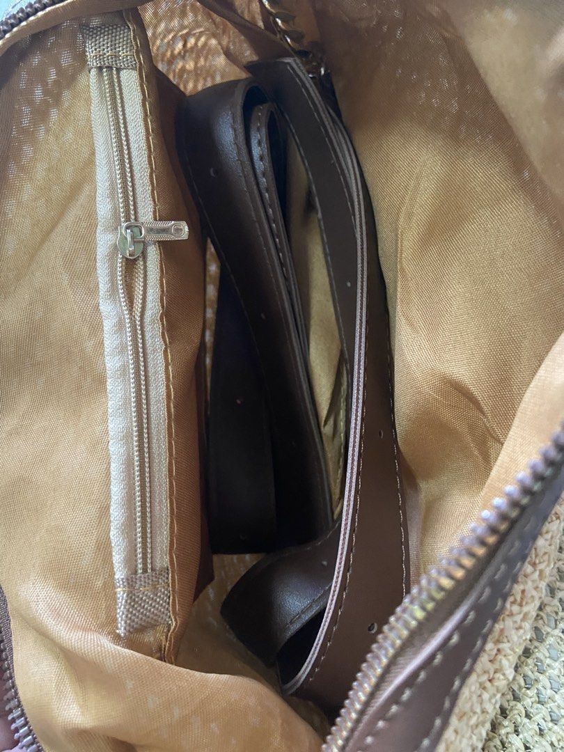 Woven Straw Handbag with Brown Leather Trim and Strap (Category: Shoulder Bags) located in Silang. Submitted by Apple_Mac07 (Listing ID 1465843321, Image 2). Description: - Style: Summer woven straw shoulder bag - Color: Beige with brown synthetic leather trim - Closure: Secure top zipper - Interior: Gold fabric lining with a convenient zippered inner pocket - Includes brown adjustable strap inside - Features: Lightweight, spacious, and perfect f