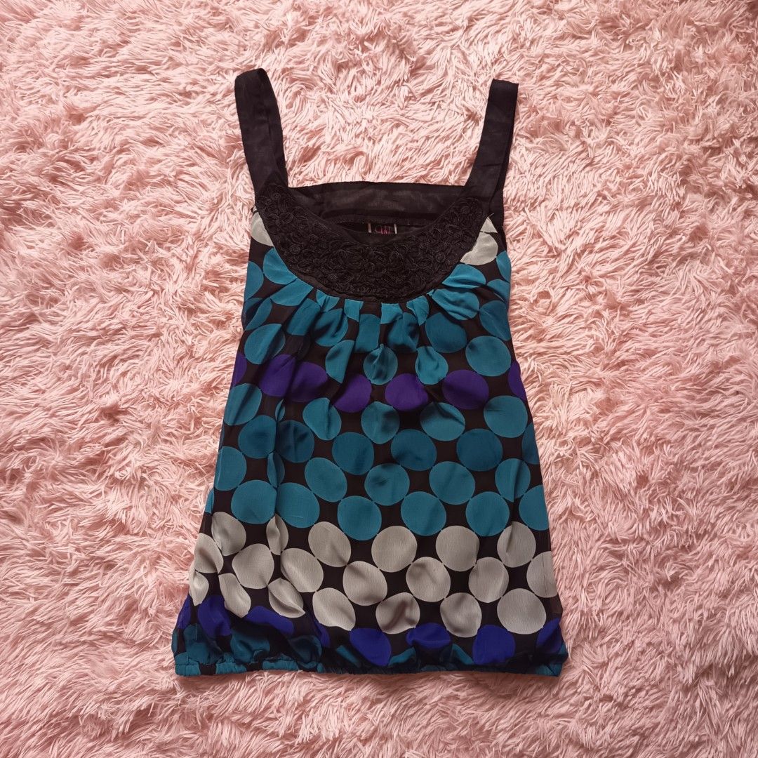 Wrapper | Y2K bubble polka dot top (Category: Sleeveless) located in Adams. Submitted by luckygirl.closet (Listing ID 1460571332, Image 1). Description: M on tag No issues Puffy princess style vibrant mix of turquoise, purple, and white polka dots with a black lace scoop neckline.