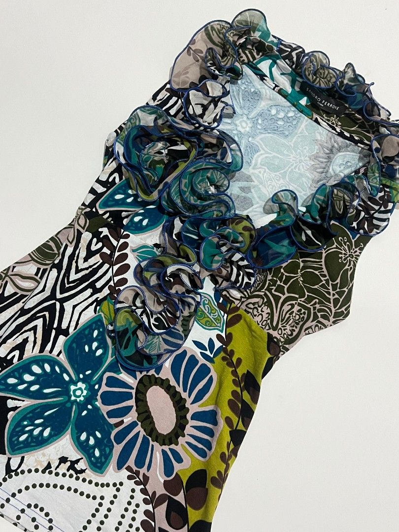 Y2k 2000s Sandro Ferrone Roma Floral Ruffle Top (Category: Sleeveless) located in Kidapawan. Submitted by rav.rose (Listing ID 1465942518, Image 3). Description: - Brand: Sandro Ferrone Roma - Design: Bold mixed floral pattern in blues, greens, and neutrals - Detail: Dramatic ruffled collar trimmed with chic blue piping - Cut: Sleeveless - Condition: Excellent, authentic fabric label intact - Style Tip: Great for pairing with slacks or skirts for