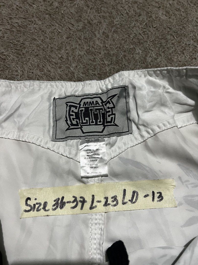 Y2K MMA Elite white board shorts (Category: Shorts) located in Mexico. Submitted by iseemiyakee. (Listing ID 1465926650, Image 3). Description: Size 36-37 Length 23 Leg opening 13 Noissue Excellent Condition .