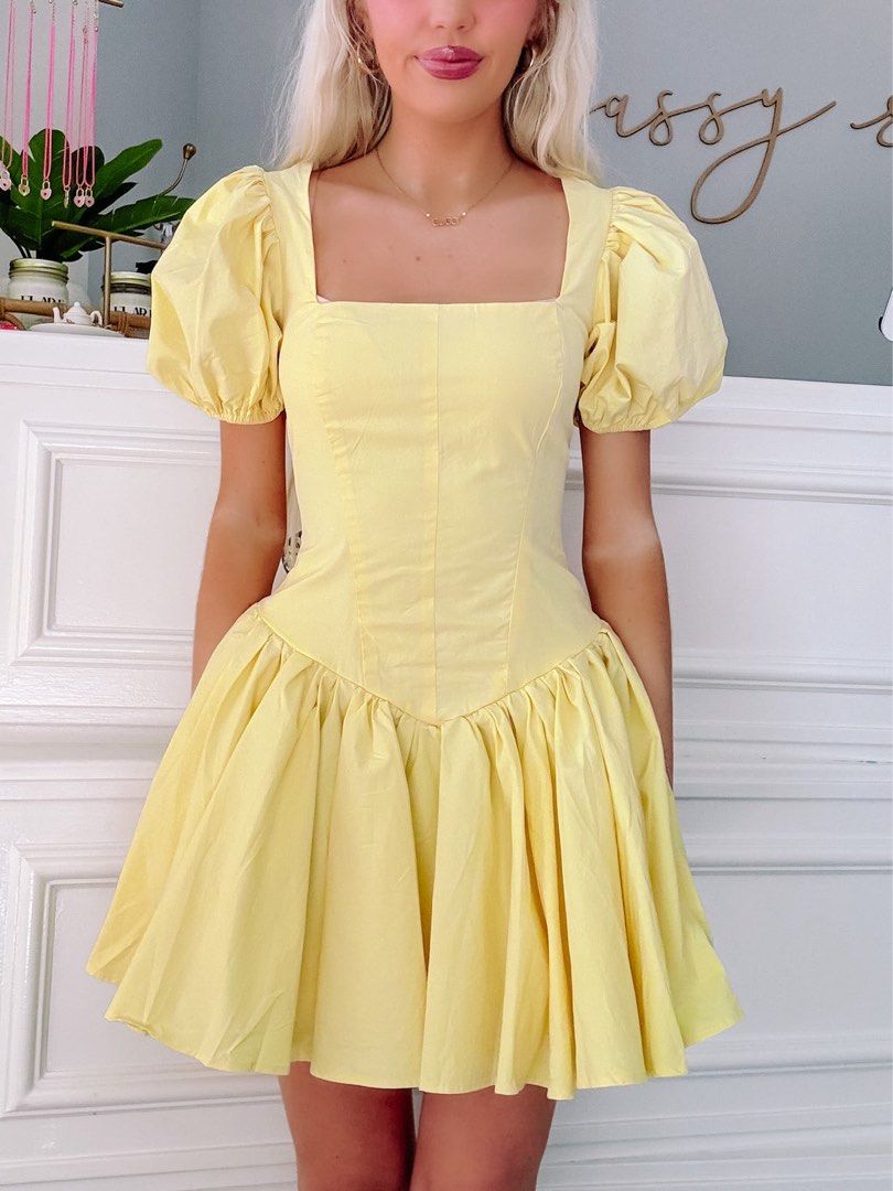 Yellow Puff Sleeve Square Neck Mini Dress (Category: Dresses) located in Iloilo. Submitted by ele.girl (Listing ID 1465765579, Image 1). Description: - Color: Butter yellow - Material: Lightweight cotton - Design: Square neckline & short puff sleeves - Fit: Fitted bodice with paneled seams and a flared, pleated skirt - Styling: Perfect to pair with heels for events or sneakers for a casual look.