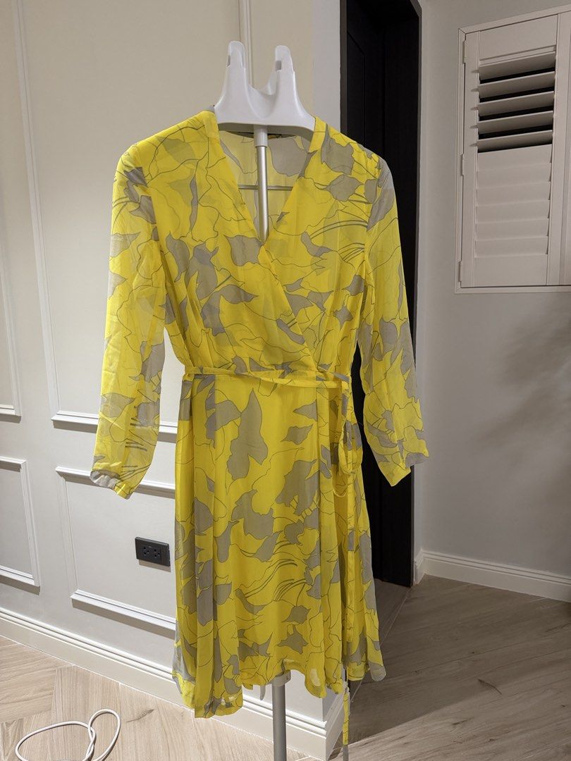 Zara Basic Yellow Floral Wrap Dress Size L (Category: Dresses) located in Makati City. Submitted by 1st_Dibs (Listing ID 1465800557, Image 3). Description: - Brand: Zara Basic - Size: L (Made in Morocco) - Color/Pattern: Bright yellow with grey floral print - Style: V-neckline, long sleeves, tie waist detail, knee length - Material: Light and flowy - Condition: Clean, from a smoke-free home - Best for: Casual outings and warm weather.