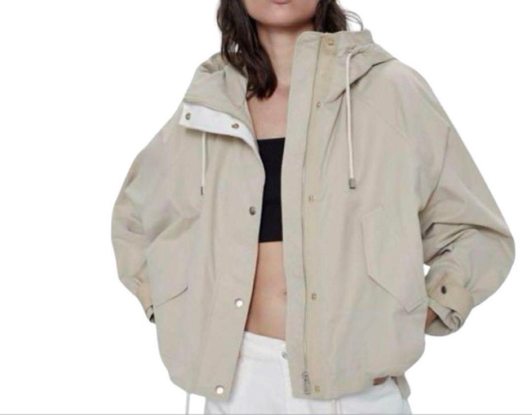 Zara Beige Hooded Utility Parka Jacket (Category: Coats, Jackets and Outerwear) located in Quezon City. Submitted by dropdeadprices (Listing ID 1465939213, Image 3). Description: - Color: Versatile beige - Fit: Relaxed, trendy oversized fit - Closure: Full zip front with snap button flap - Features: Funnel neck, Adjustable drawstrings at hood and hem, front flap pockets, and button cuffs - Material: Lightweight and ideal for rainy days or air-con