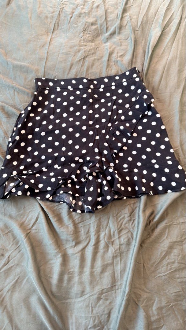 Zara Black Polka Dot Ruffle Skort Size S (Category: Skirts) located in Batangas. Submitted by krieldre (Listing ID 1465776496, Image 1). Description: - Brand: Zara - Size: S - Pattern: Black and white polka dot - Style: Wrap front with playful ruffle trim and side zip closure - Fabric: Lightweight and perfect for warm weather - Versatility: Easy to style with heels for a night out or sneakers for casual days.