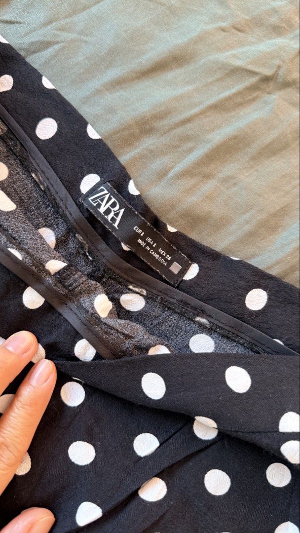 Zara Black Polka Dot Ruffle Skort Size S (Category: Skirts) located in Batangas. Submitted by krieldre (Listing ID 1465776496, Image 3). Description: - Brand: Zara - Size: S - Pattern: Black and white polka dot - Style: Wrap front with playful ruffle trim and side zip closure - Fabric: Lightweight and perfect for warm weather - Versatility: Easy to style with heels for a night out or sneakers for casual days.