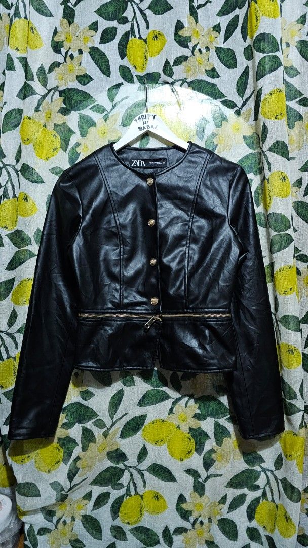 Zara Faux Leather Black Jacket (Category: Coats, Jackets and Outerwear) located in Kibawe. Submitted by Thrift_ni_Babac (Listing ID 1465876172, Image 1). Description: - Brand: Zara - Size: XS - Color: Black with chic gold hardware - Style: Cropped fit with zip closures and neckline button details - Condition: Pre-loved with an issue on one sleeve (as pictured) .