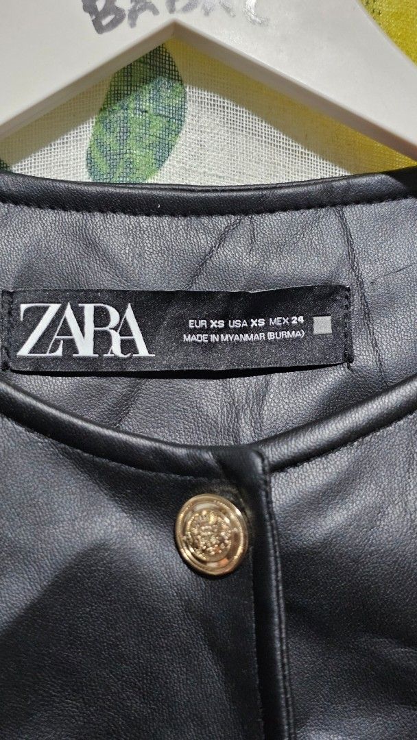Zara Faux Leather Black Jacket (Category: Coats, Jackets and Outerwear) located in Kibawe. Submitted by Thrift_ni_Babac (Listing ID 1465876172, Image 3). Description: - Brand: Zara - Size: XS - Color: Black with chic gold hardware - Style: Cropped fit with zip closures and neckline button details - Condition: Pre-loved with an issue on one sleeve (as pictured) .