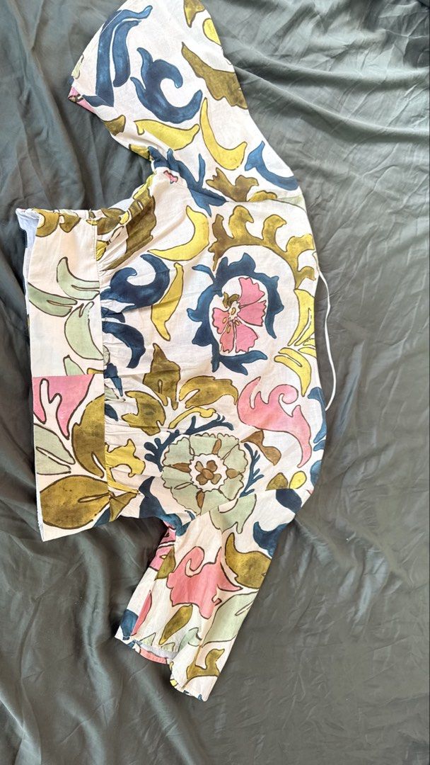 Zara Floral Print Blouse Size M (Category: Blouses) located in Batangas. Submitted by krieldre (Listing ID 1465777461, Image 2). Description: - Brand: Zara - Size: M (Made in Morocco) - Design: Colorful abstract floral pattern (pink, blue, yellow, green) - Details: V-neckline with hanging string, short sleeves, gathered waist hem - Material: Lightweight and breathable fabric - Condition: Excellent pre-loved condition (ready to wear).