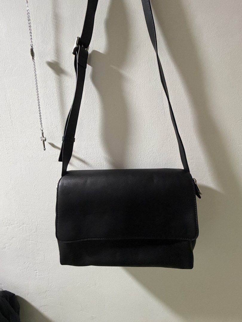 ZARA leather crossbody messenger bag with adjustable strap (Category: Cross-body Bags) located in Manila. Submitted by lowideyn (Listing ID 1465824482, Image 1). Description: - Color & Material: Black faux leather - Closure: Magnetic snap flap with extra top zipper for security - Strap: Adjustable with metal buckle - Capacity: Roomy main compartment fits a standard tablet or iPad - Condition: Clean inside and out, smoke-free home - unused.