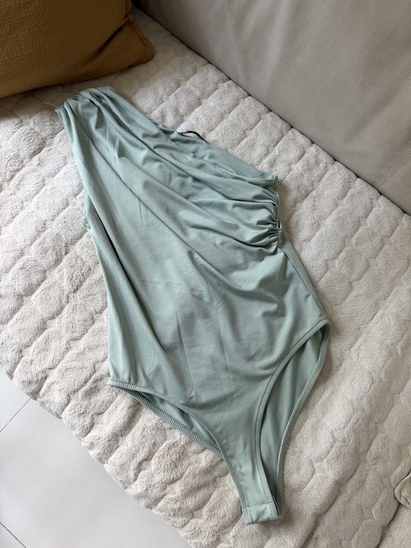 Zara One-Shoulder Draped Bodysuit Sage Green Size S (Category: Sleeveless) located in Pasay City. Submitted by closetbykim (Listing ID 1465787749, Image 3). Description: - Brand: Zara - Style: One-shoulder bodysuit with draped front and side ruching - Color: Soft sage green - Size: S - Condition: Worn once or twice, excellent shape - Material: Smooth and stretchy - Styling tip: Looks great with white trousers or denim jeans.
