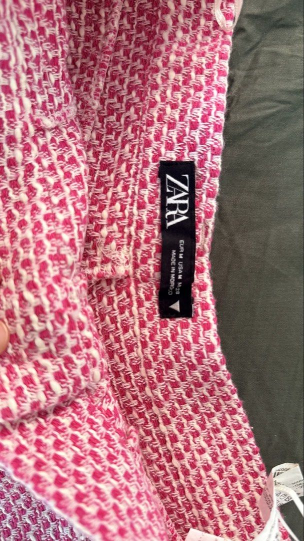Zara Pink Tweed Shorts Size M (Category: Shorts) located in Batangas. Submitted by krieldre (Listing ID 1465778204, Image 2). Description: - Brand: Zara - Size: M (interior tag) - Condition: Brand new, never worn with hanger straps still attached - Design: Pink and white textured woven tweed fabric - Fit: Mid-rise - Details: Frayed edges along pockets and waistband, secure button closure.