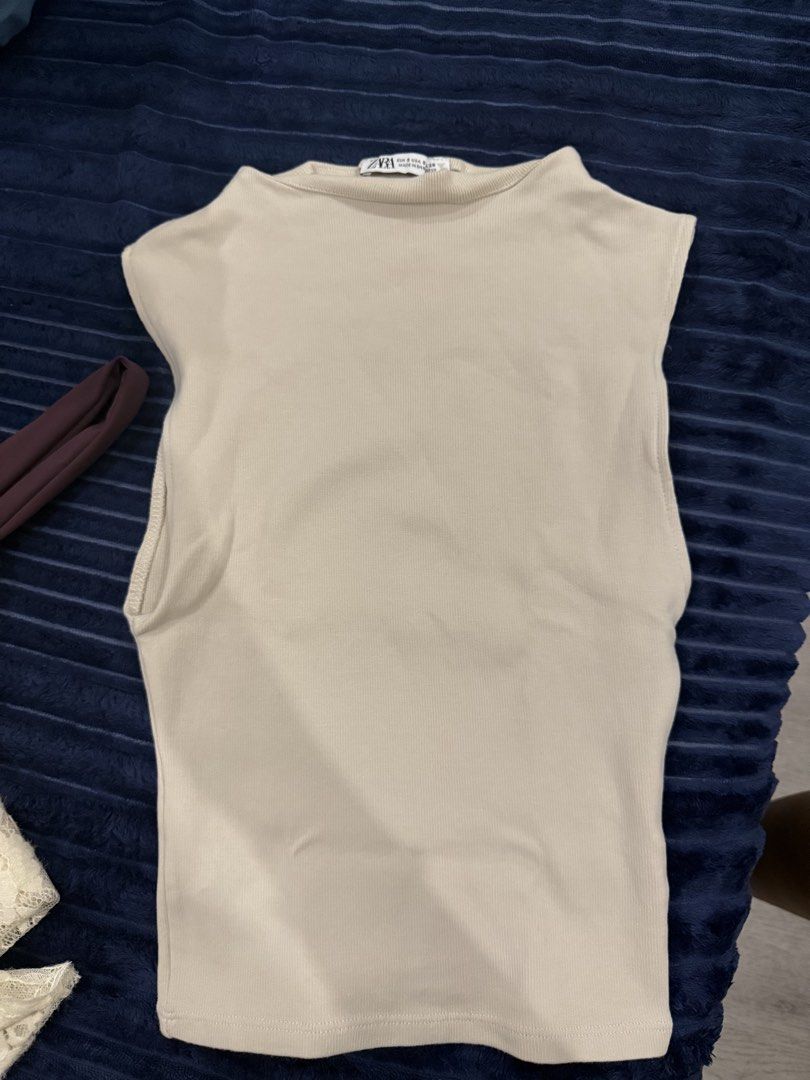 Zara Ribbed Sleeveless Beige Top (Category: Sleeveless) located in Makati City. Submitted by stallionmegx (Listing ID 1465915670, Image 1). Description: - Brand: Zara - Color: Beige - Size: S (Made in Bangladesh) - Style: Sleeveless, high round neckline, ribbed texture - Material: Comfortable stretch fabric - Condition: Great, clean with no stains or damage - Perfect basic piece for everyday wear and easy to style with jeans or skirts.