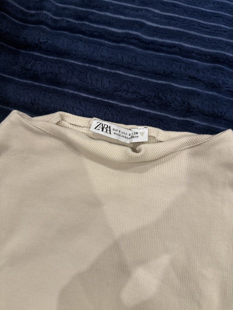 Zara Ribbed Sleeveless Beige Top (Category: Sleeveless) located in Makati City. Submitted by stallionmegx (Listing ID 1465915670, Image 2). Description: - Brand: Zara - Color: Beige - Size: S (Made in Bangladesh) - Style: Sleeveless, high round neckline, ribbed texture - Material: Comfortable stretch fabric - Condition: Great, clean with no stains or damage - Perfect basic piece for everyday wear and easy to style with jeans or skirts.
