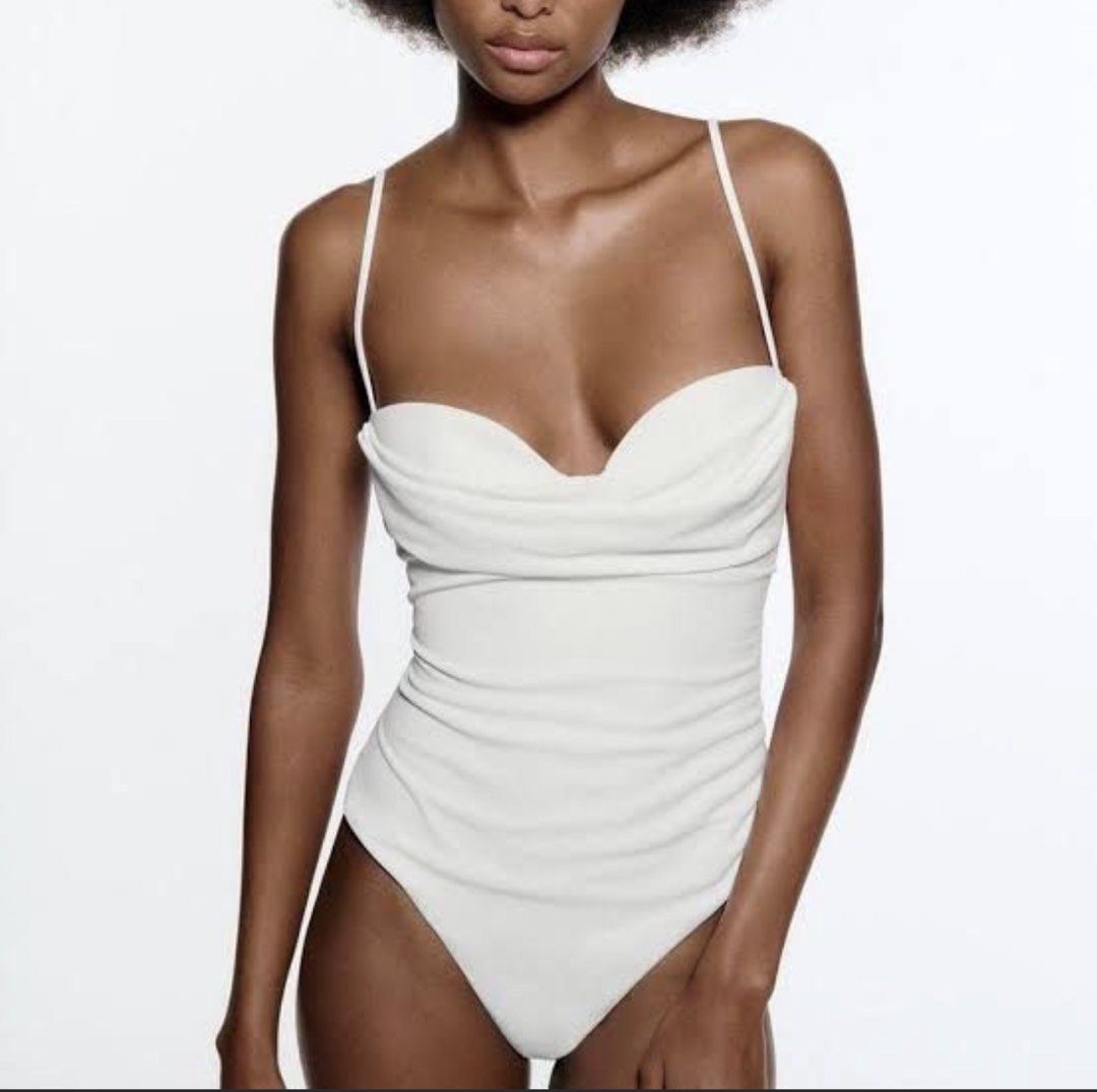 Zara white drape bodysuit XS (Category: Sleeveless) located in Pasay City. Submitted by closetbykim (Listing ID 1465819804, Image 1). Description: - Brand/Model: Zara Bodysuit - Size: EUR XS - Color: White - Design: Cowl neckline with spaghetti straps and back zipper closure - Material: Soft textured fabric with a super flattering fit - Styling: Pairs easily with jeans or skirts for a night out.