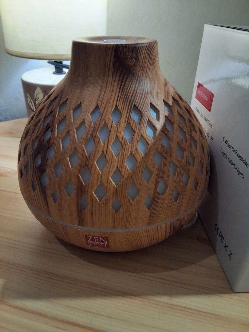 Zen Zest Wood Grain Essential Oil Diffuser (Category: Home Fragrance) located in Quezon City. Submitted by vettylafea (Listing ID 1465874771, Image 1). Description: RFS: kakabili ko lang po nitong unit for 1500 pesos sa mismong zen zest physical store pero meron na pala yung pag reregaluhan ko. Ginamit ko isang beses para mas ma-testing lang at okay naman. No issue po siya. inclusions: cable/adaptor, manual and the box itself..