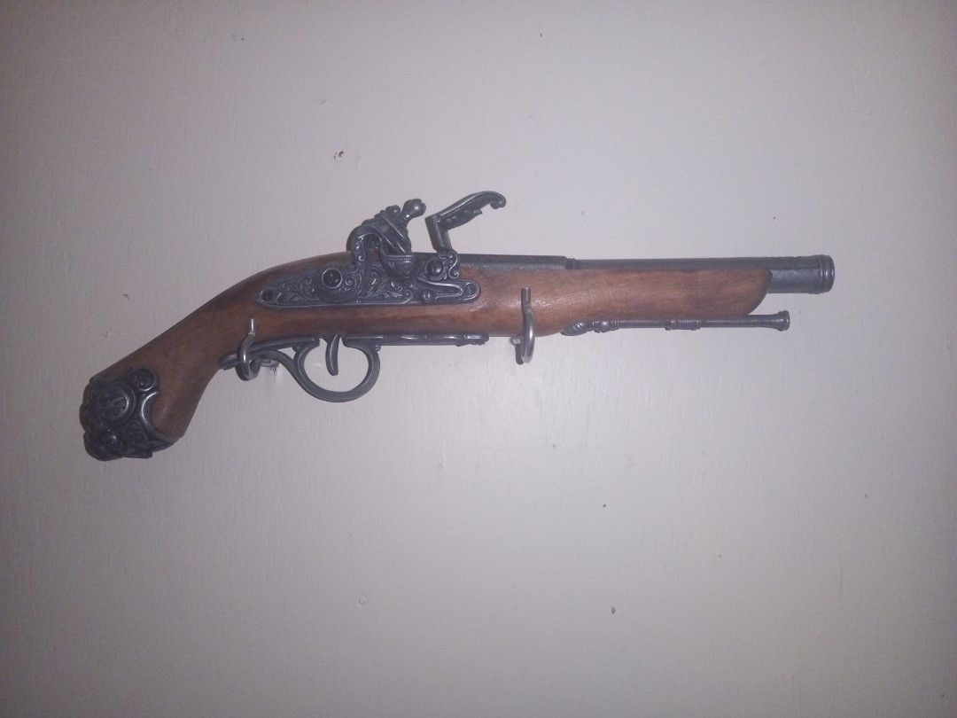 18th Century Flintlock Pistol (Replica) (Category: Vintage Collectibles) located in Baguio. Submitted by silentturtle.5ec778 (Listing ID 1465994703, Image 1). Description: Flintlock pistols were so called because the lock uses a flint to strike sparks into the priming pan when the trigger is pulled. A small amount of gunpowder in this pan is ignited, which in turn ignites the main gunpowder charge in the barrel, firing the lead ball. Both the mai