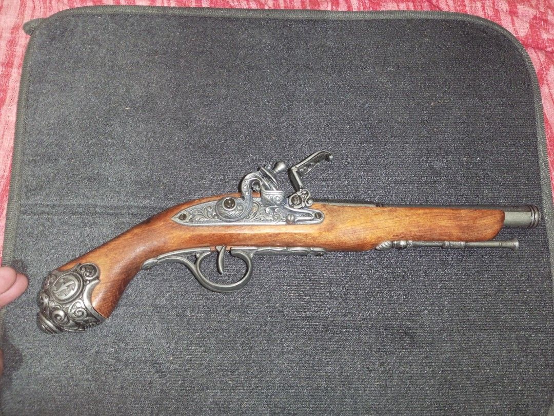 18th Century Flintlock Pistol (Replica) (Category: Vintage Collectibles) located in Baguio. Submitted by silentturtle.5ec778 (Listing ID 1465994703, Image 2). Description: Flintlock pistols were so called because the lock uses a flint to strike sparks into the priming pan when the trigger is pulled. A small amount of gunpowder in this pan is ignited, which in turn ignites the main gunpowder charge in the barrel, firing the lead ball. Both the mai