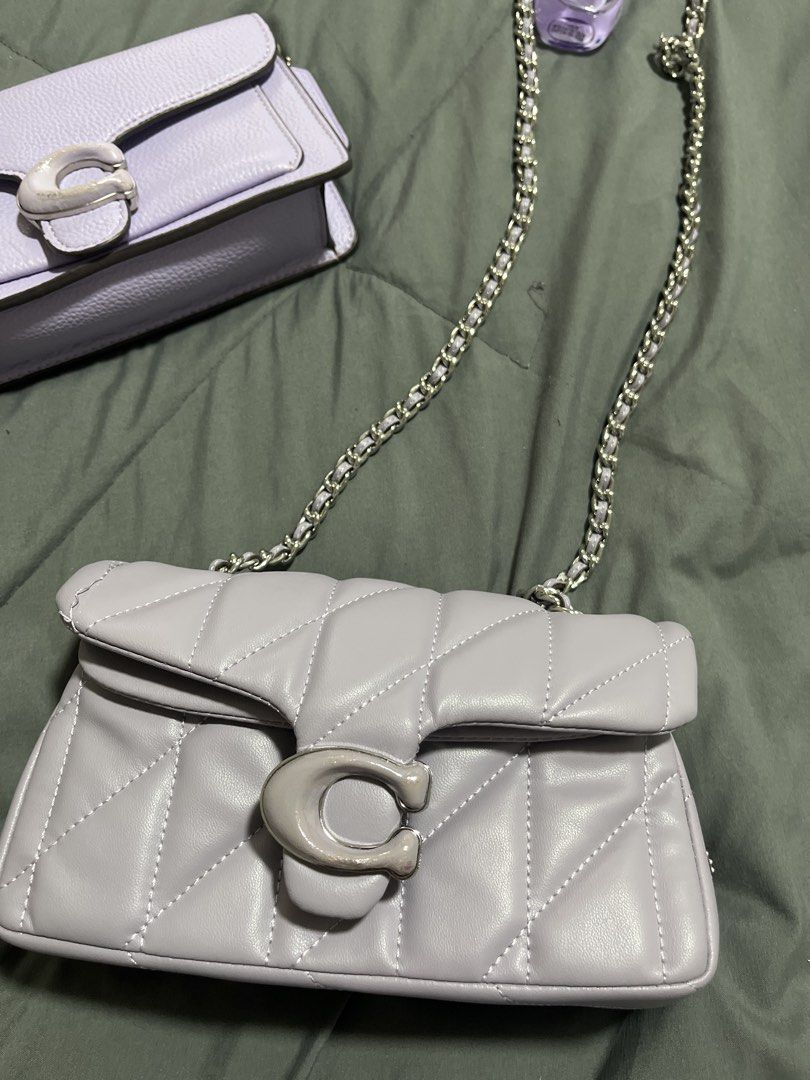 2 Pieces preloved Coach Purple Tabby Shoulder Bag (Category: Shoulder Bags) located in Pasig City. Submitted by melaiski28 (Listing ID 1465977465, Image 3). Description: - Coach shoulder bag in gorgeous light purple leather -OEM - Silver-tone hardware with iconic signature C clasp closure - Includes a stylish chain strap for versatile wear - Features a convenient front slip pocket under the flap - Interior includes a secure zipped compartment and