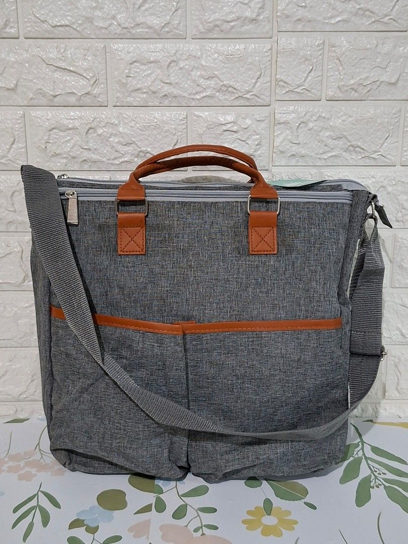👶👜 Stylish Gray Diaper Bag (Category: Diaper Bags & Wetbags) located in Taguig. Submitted by authprelovedonlineshop2 (Listing ID 1466007881, Image 1). Description: ### 👶👜 Stylish Gray Diaper Bag **Brand New! ✨** Unused! - Elegant **gray diaper bag** with brown leather accents - Spacious interior with **multiple compartments** - Includes **shoulder strap & top handles** - Secure **zippered closure** - Convenient **exterior pockets** for easy a