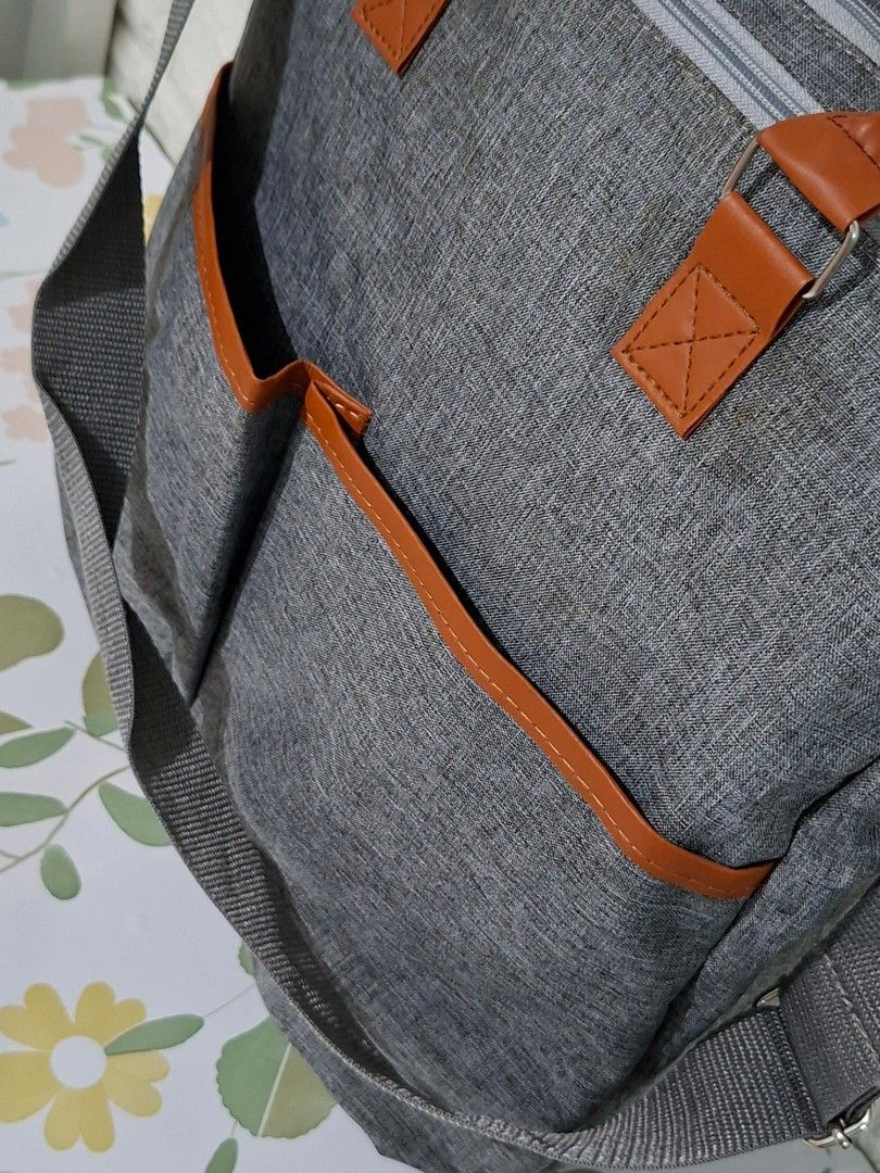 👶👜 Stylish Gray Diaper Bag (Category: Diaper Bags & Wetbags) located in Taguig. Submitted by authprelovedonlineshop2 (Listing ID 1466007881, Image 2). Description: ### 👶👜 Stylish Gray Diaper Bag **Brand New! ✨** Unused! - Elegant **gray diaper bag** with brown leather accents - Spacious interior with **multiple compartments** - Includes **shoulder strap & top handles** - Secure **zippered closure** - Convenient **exterior pockets** for easy a