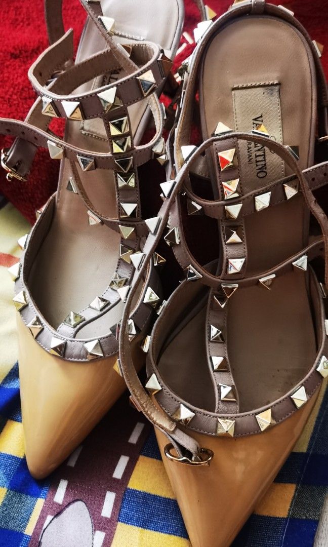 💯 VALENTINO GARAVANI Rockstud ankle strap pump (Category: Sneakers & Footwear) located in Cainta. Submitted by phengaying (Listing ID 1466016959, Image 2). Description: Original valentino garavani rockstud ankle strap pump, size 38 or Us6, best for slim feet, 6.5cm heels, double ankle strap with metal rockstud designs. With free balenciaga Red dustbag. Flaws: ✌️ patent leather is a bit yellowish tan in color, 👌 with Black ink stain at the left 