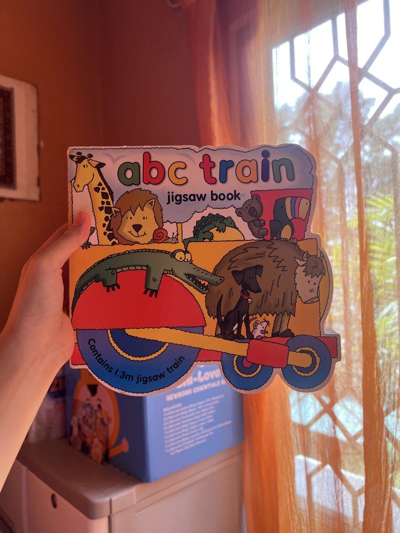 ABC Train Jigsaw Book (Category: Children's Books) located in Quezon City. Submitted by joybautista05 (Listing ID 1465972797, Image 1). Description: - Educational ABC train jigsaw book for toddlers - Features cute animal illustrations like giraffes, lions, and alligators - Includes an interactive 1.3m train puzzle - Durable board book format with sturdy pages made for little hands - Great activity for learning letters and animals.