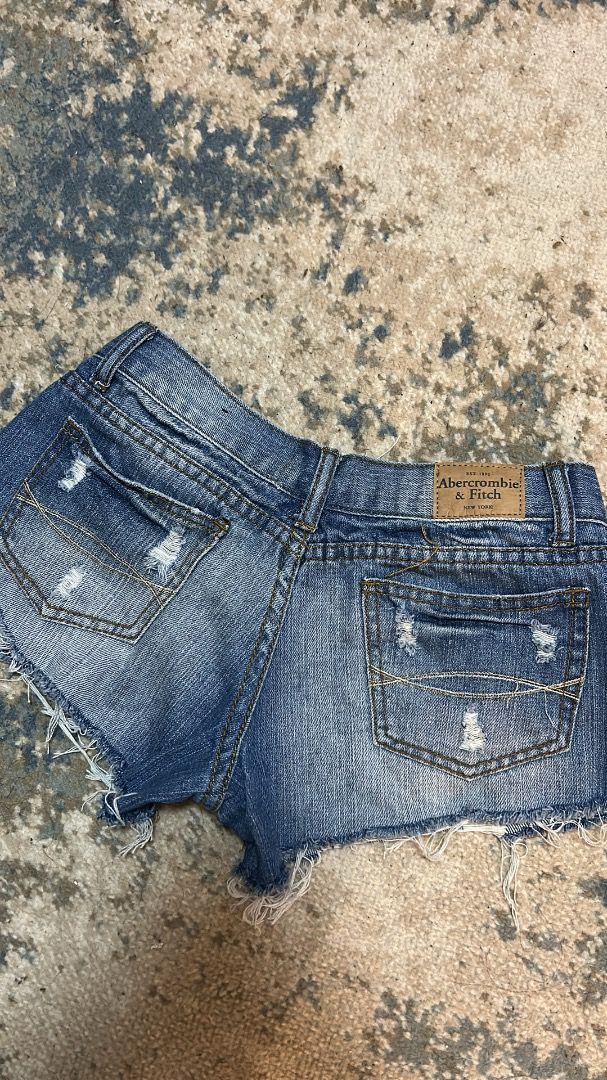 Abercrombie & Fitch denim micro shorts (Category: Shorts) located in Manila. Submitted by cvntlab (Listing ID 1466122484, Image 2). Description: - Brand: Abercrombie & Fitch - Style: Low-rise denim jean shorts - Wash: Medium wash with heavy distressing - Details: Raw frayed hems and classic 5-pocket design - Fit: True to size - Condition: Great for summer, casual wear, and beach trips.