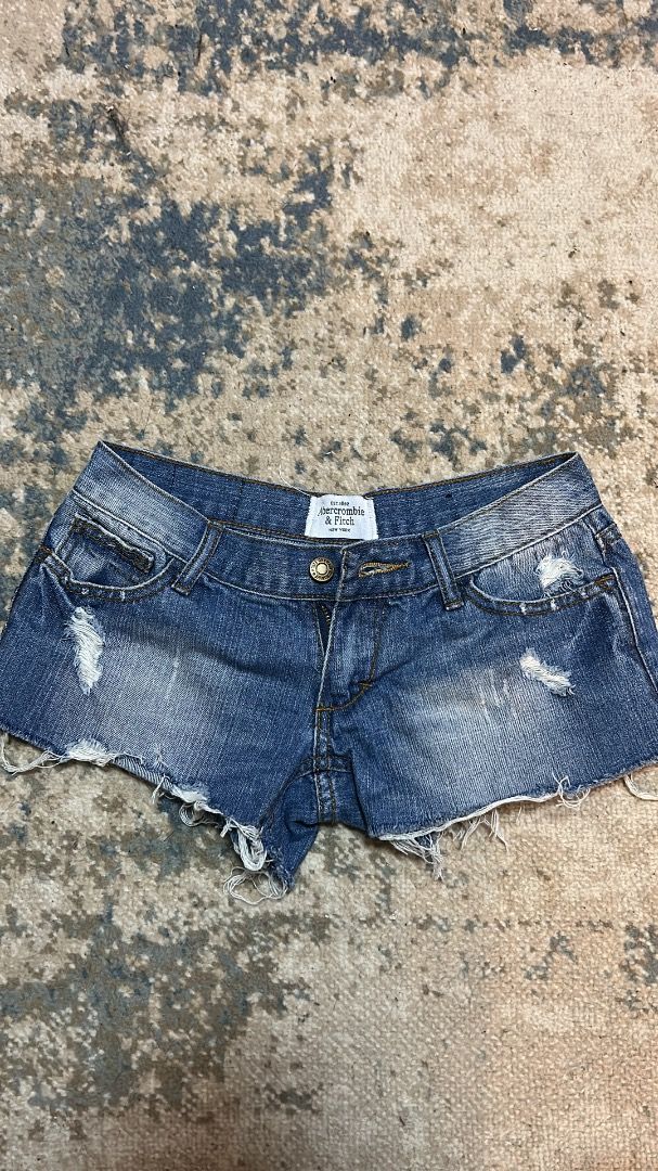 Abercrombie & Fitch denim micro shorts (Category: Shorts) located in Manila. Submitted by cvntlab (Listing ID 1466122484, Image 1). Description: - Brand: Abercrombie & Fitch - Style: Low-rise denim jean shorts - Wash: Medium wash with heavy distressing - Details: Raw frayed hems and classic 5-pocket design - Fit: True to size - Condition: Great for summer, casual wear, and beach trips.