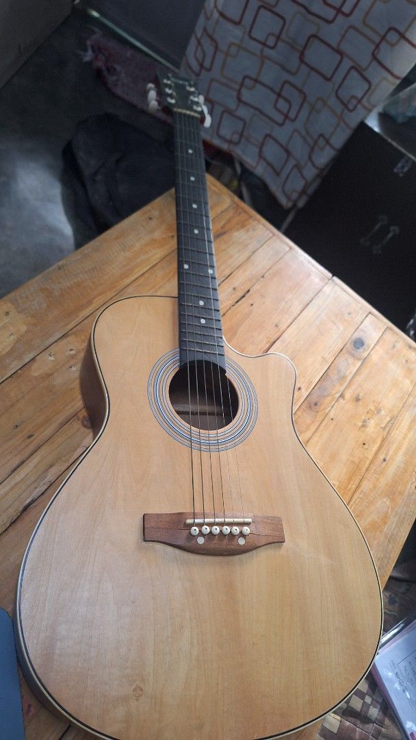 Acoustic Guitar Natural Top Red Back Cutaway (Category: Musical Instruments) located in Pasig City. Submitted by kimiris_30 (Listing ID 1466033821, Image 1). Description: - Beautiful acoustic guitar with natural wood top and striking red wood-grain back/sides - Cutaway body shape for comfortable and easy upper fret access - Dark fretboard with classic dot inlays and reliable metal tuning pegs - Delivers a decent, warm acoustic sound - Condition: 