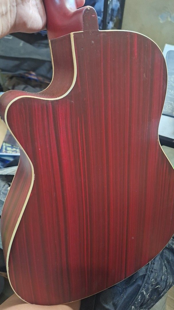 Acoustic Guitar Natural Top Red Back Cutaway (Category: Musical Instruments) located in Pasig City. Submitted by kimiris_30 (Listing ID 1466033821, Image 2). Description: - Beautiful acoustic guitar with natural wood top and striking red wood-grain back/sides - Cutaway body shape for comfortable and easy upper fret access - Dark fretboard with classic dot inlays and reliable metal tuning pegs - Delivers a decent, warm acoustic sound - Condition: 