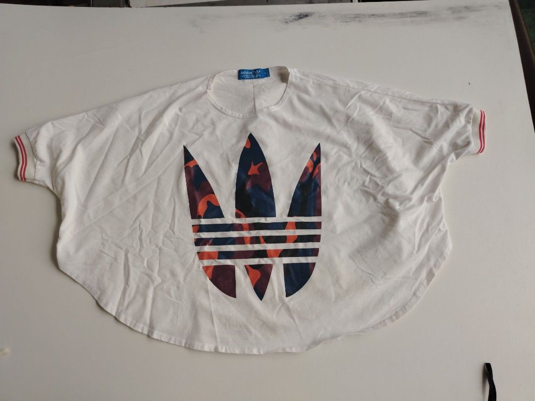 Addidas original tee (Category: Shirts) located in Manila. Submitted by rockandrolly (Listing ID 1466153191, Image 1). Description: Adidas Originals Tee — Size S ✔️ 100% Authentic ✔️ Camo Trefoil big logo ✔️ Red trim sleeves ✔️ Clean, well-maintained ✔️ Size S — relaxed cut ✔️ Blue tag — genuine Originals.