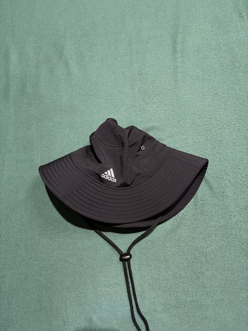 Adidas Aeroready Black Bucket Hat (Category: Caps & Hats) located in Guihulngan. Submitted by fbthriftgoodsniace (Listing ID 1466004836, Image 2). Description: - Brand: Adidas - Color: Classic black with white embroidered logo - Tech: Aeroready sweatband keeps you dry - Comfort: Lightweight polyester blend with mesh lining - Features: Adjustable chin strap with toggle for a secure fit - Condition: Clean inside and out, perfect for outdoor activit