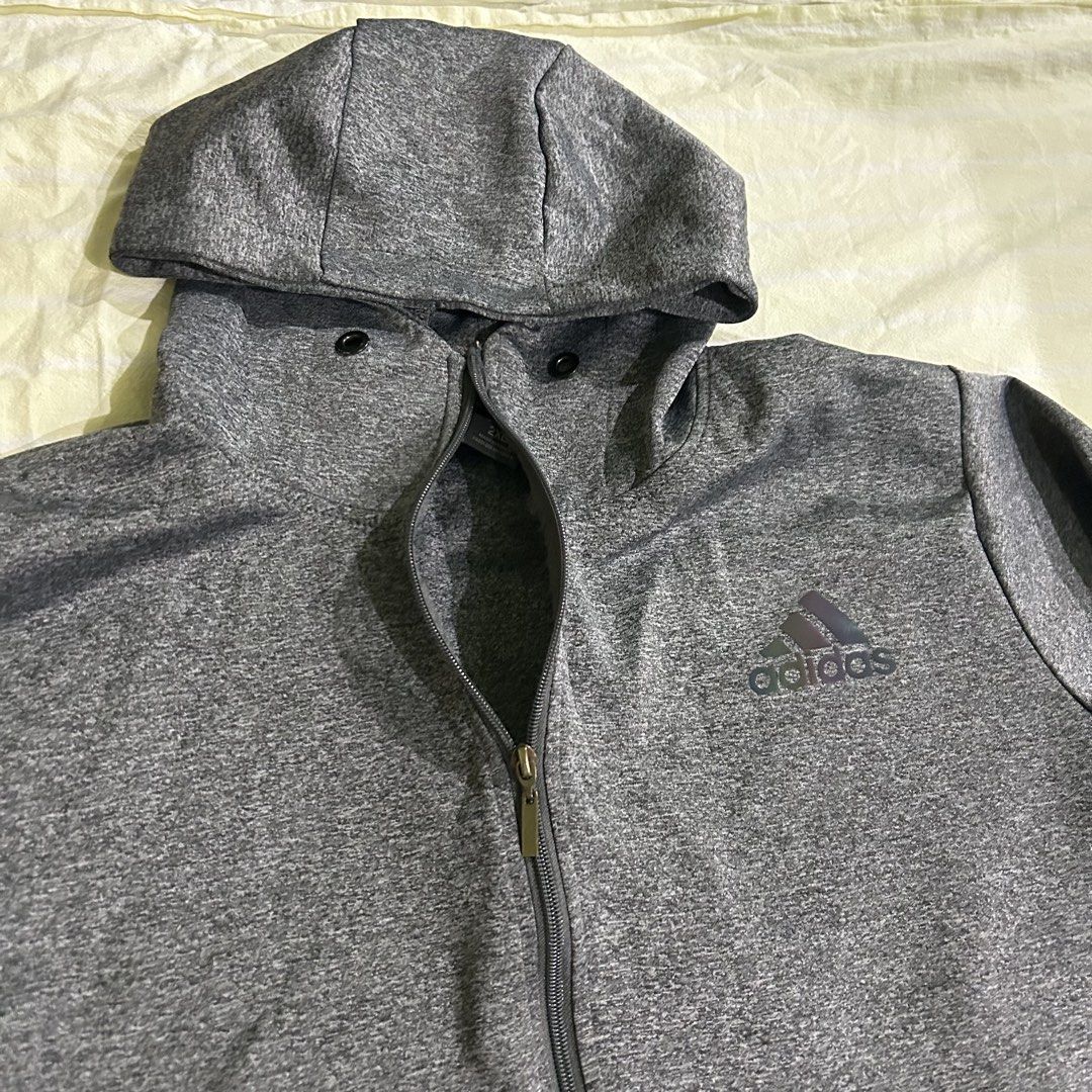 adidas authentic grey jacket with reflective logo (Category: Activewear) located in Rizal. Submitted by vivismuse (Listing ID 1465982650, Image 3). Description: with flaw: small hole at the back of hoodie.