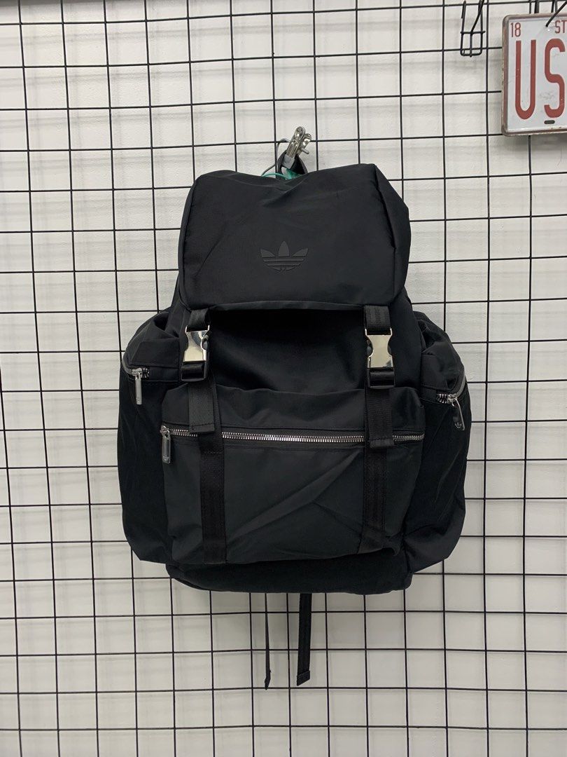 Adidas Black Street Flip Backpack (Category: Backpacks) located in Cavite. Submitted by jeromeaba95864 (Listing ID 1466109588, Image 1). Description: - Authentic Adidas backpack in sleek black - Secure flap closure with stylish shiny metal buckles - Multiple zippered front and side compartments for easy organization - Durable, heavy-duty black nylon straps - Subtle tonal trefoil logo and branded zipper pulls - Spacious interior ideal for school, 