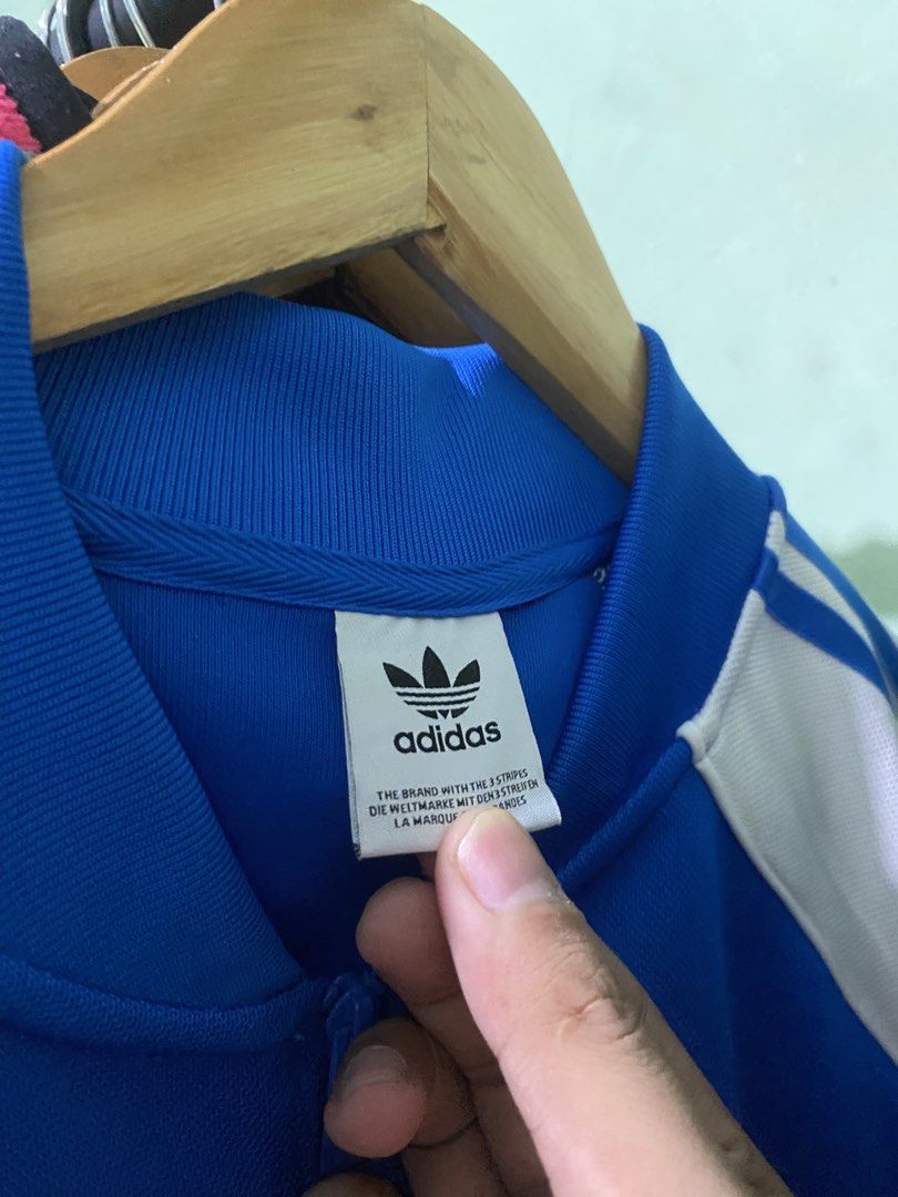 Adidas Blue White Track Jacket (Category: Coats, Jackets and Outerwear) located in Tiaong. Submitted by maticbuy (Listing ID 1465965693, Image 2). Description: - Brand: Adidas - Color: Bright blue with white stripes - Features: Full zip closure, stand-up collar, front pockets - Details: Embroidered Trefoil logo on chest - Condition: Clean fabric, ready to wear.