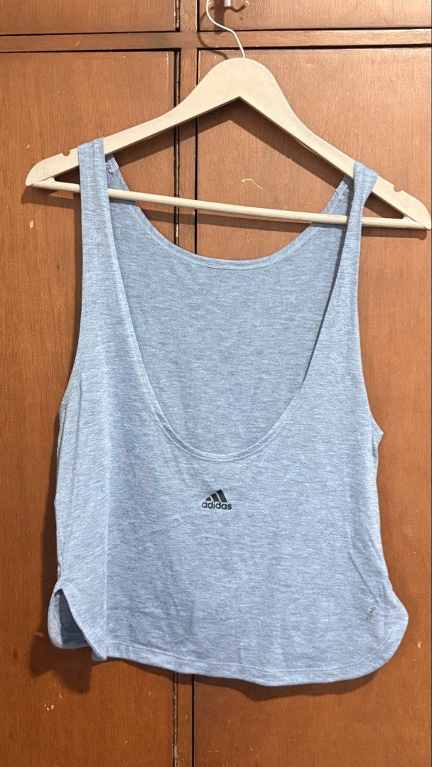 Adidas Grey Workout Tank Top (Category: Activewear) located in Pasig City. Submitted by 35th.store (Listing ID 1466152803, Image 3). Description: - Brand new with tags still attached - Authentic grey Adidas workout tank top - Lightweight and highly breathable fabric for gym or running - Trendy low scoop back design - Subtle black Adidas logo near the hem - Rounded hemline with a slightly longer back for extra coverage.