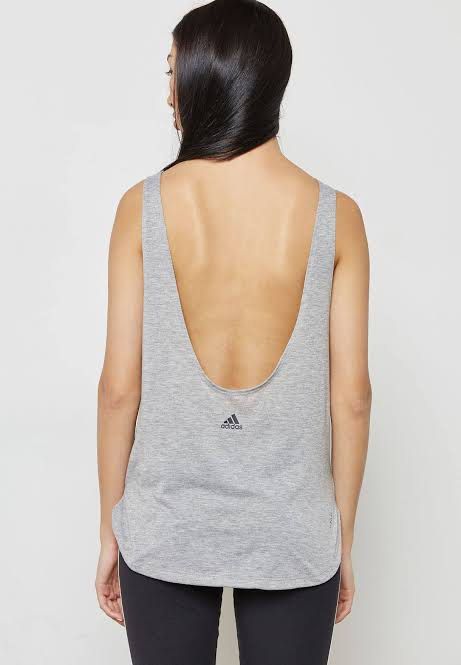 Adidas Grey Workout Tank Top (Category: Activewear) located in Pasig City. Submitted by 35th.store (Listing ID 1466152803, Image 2). Description: - Brand new with tags still attached - Authentic grey Adidas workout tank top - Lightweight and highly breathable fabric for gym or running - Trendy low scoop back design - Subtle black Adidas logo near the hem - Rounded hemline with a slightly longer back for extra coverage.