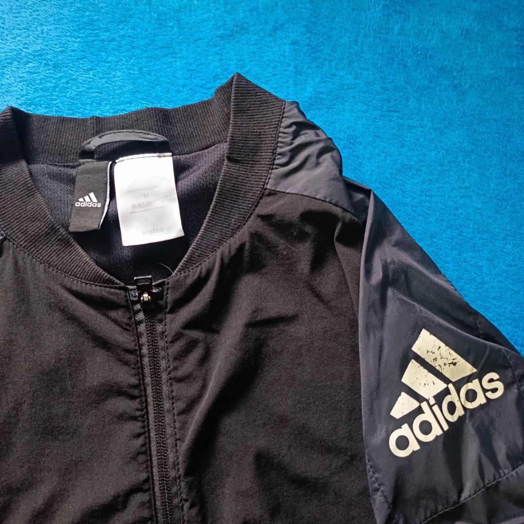 Adidas Lightweight Windbreaker Jacket (Category: Coats, Jackets and Outerwear) located in Antipolo. Submitted by juliane_thrift-declutters (Listing ID 1466126099, Image 3). Description: Adidas Lightweight Windbreaker Jacket Dimes: 25.5×22.5 Size: Medium Best fit to Medium to Large • Minimal Crack Prints • Printed Logo • Complete Wash tags • Overall Condition: 9/10 * Color may vary due to lighting.