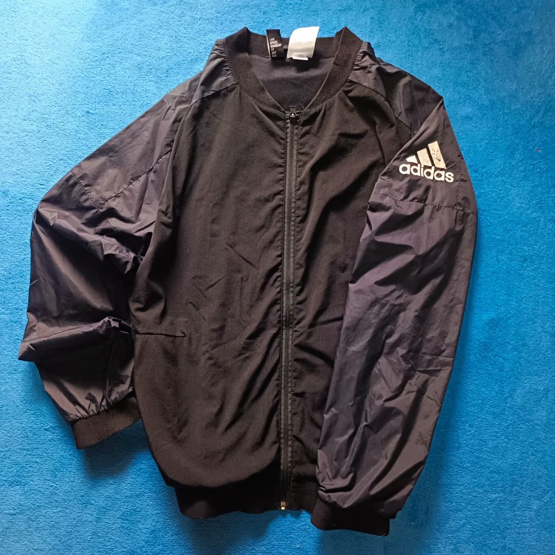 Adidas Lightweight Windbreaker Jacket (Category: Coats, Jackets and Outerwear) located in Antipolo. Submitted by juliane_thrift-declutters (Listing ID 1466126099, Image 2). Description: Adidas Lightweight Windbreaker Jacket Dimes: 25.5×22.5 Size: Medium Best fit to Medium to Large • Minimal Crack Prints • Printed Logo • Complete Wash tags • Overall Condition: 9/10 * Color may vary due to lighting.