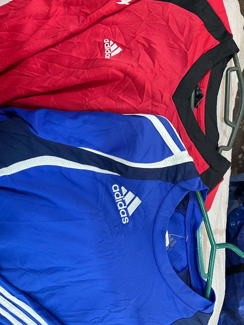 Adidas Long Sleeve Shirts Bundle Red Blue (Category: Longsleeves) located in City of Isabela. Submitted by warmbird.d06e6f (Listing ID 1466079548, Image 3). Description: - Bundle includes 2 Adidas long sleeve athletic shirts: 1 Red (with black collar and white logo) and 1 Royal Blue (with navy/white shoulder stripes and white logo) - Size: US Large (UK 38/40, F 174, D 48) - Classic crew neck design - Made in China - Ideal for workouts, football t