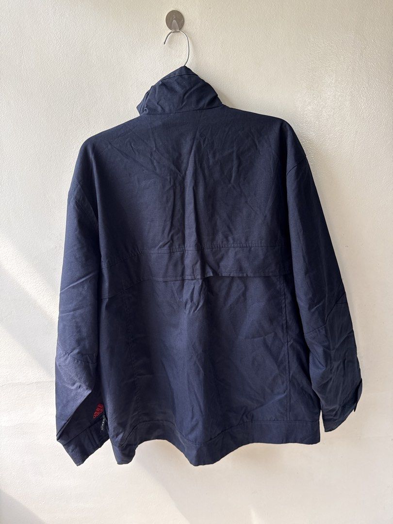 Adidas Waterproof Navy Blue Utility Jacket (Category: Coats, Jackets and Outerwear) located in Quezon City. Submitted by dropdeadprices (Listing ID 1466001259, Image 2). Description: - Brand/Style: Adidas dark navy blue jacket - Closure & Collar: Full zip front with a stand-up funnel neck collar - Pockets: Multiple functional pockets plus a secure zippered sleeve pocket - Details: embroidered Adidas logo on the left cuff - Condition/Use: very goo