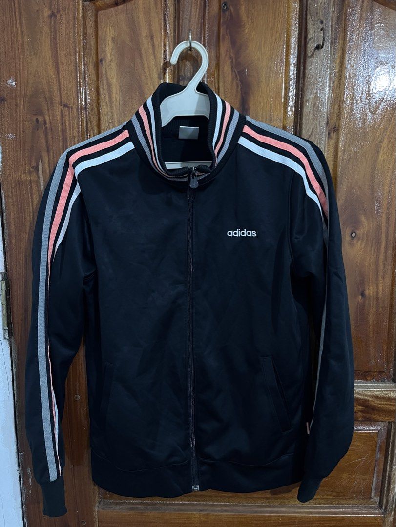 Adidas Neo Black Track Jacket Size M (Category: Coats, Jackets and Outerwear) located in Baguio. Submitted by gbwardrobe (Listing ID 1466096194, Image 1). Description: - Brand: Adidas Neo - Color: Black with pink and grey sleeve stripes - Size: Medium (fits true to size) - Material: 100% polyester - Details: Full zip closure, stand-up collar, white chest logo, ribbed cuffs and hem - Condition: Excellent / Pre-loved.