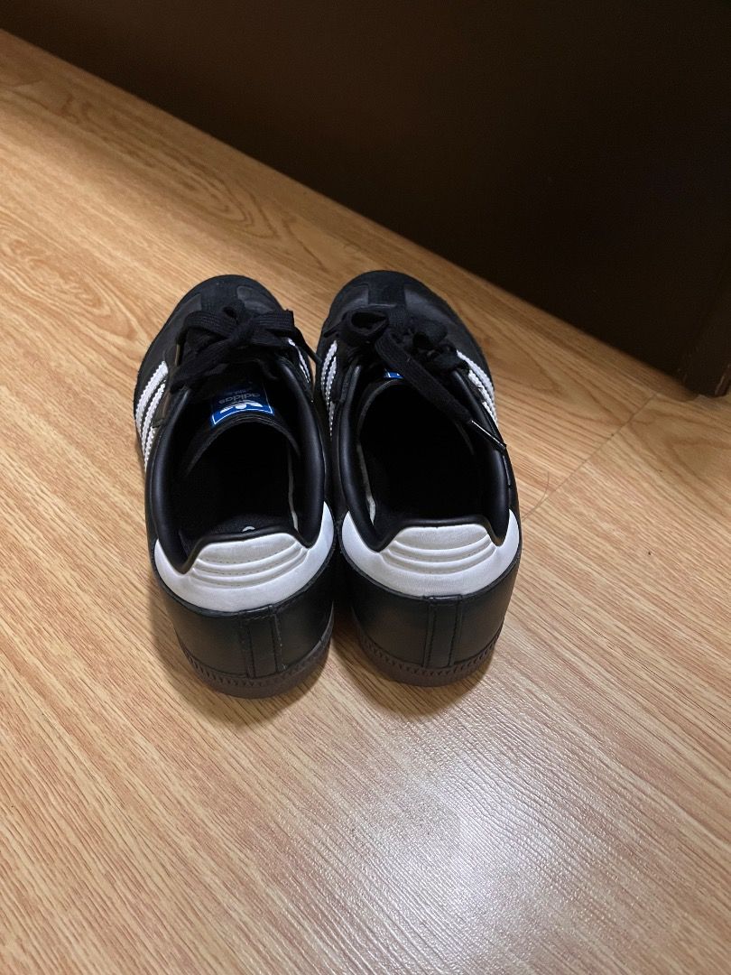 Adidas Samba Black White Sneakers (Category: Sneakers) located in Quezon City. Submitted by shop.e24 (Listing ID 1466063781, Image 2). Description: - Authentic Black and White Adidas Samba sneakers - Barely used. - Classic leather upper with iconic suede toe overlay - Stylish blue branding patch on the tongue and white heel tab - Clean soles showing minimal wear - Size tag fully readable on inner tongue - Highly versatile casual shoes, easy to ma