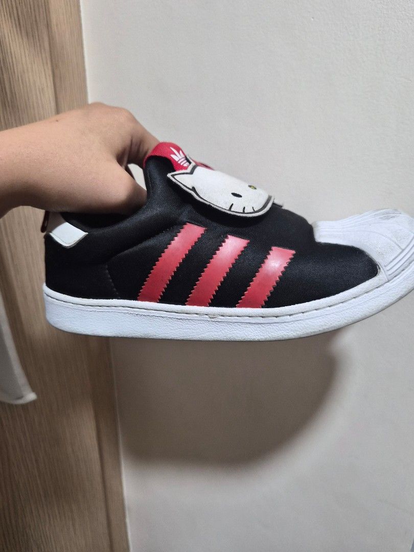 Adidas Sanrio Shoes (Category: Sneakers) located in Quezon. Submitted by imdonelle (Listing ID 1466088919, Image 2). Description: ✨ Details: • Authentic / Original Adidas • Hello Kitty design with black, white & pink/red accents • Preloved condition • With visible signs of use, particularly on the white shell/toe area and soles • Please see all photos for the actual condition 👟 Size: US 3, UK2 1/2 , CHN 210 Selling because she has already outgro