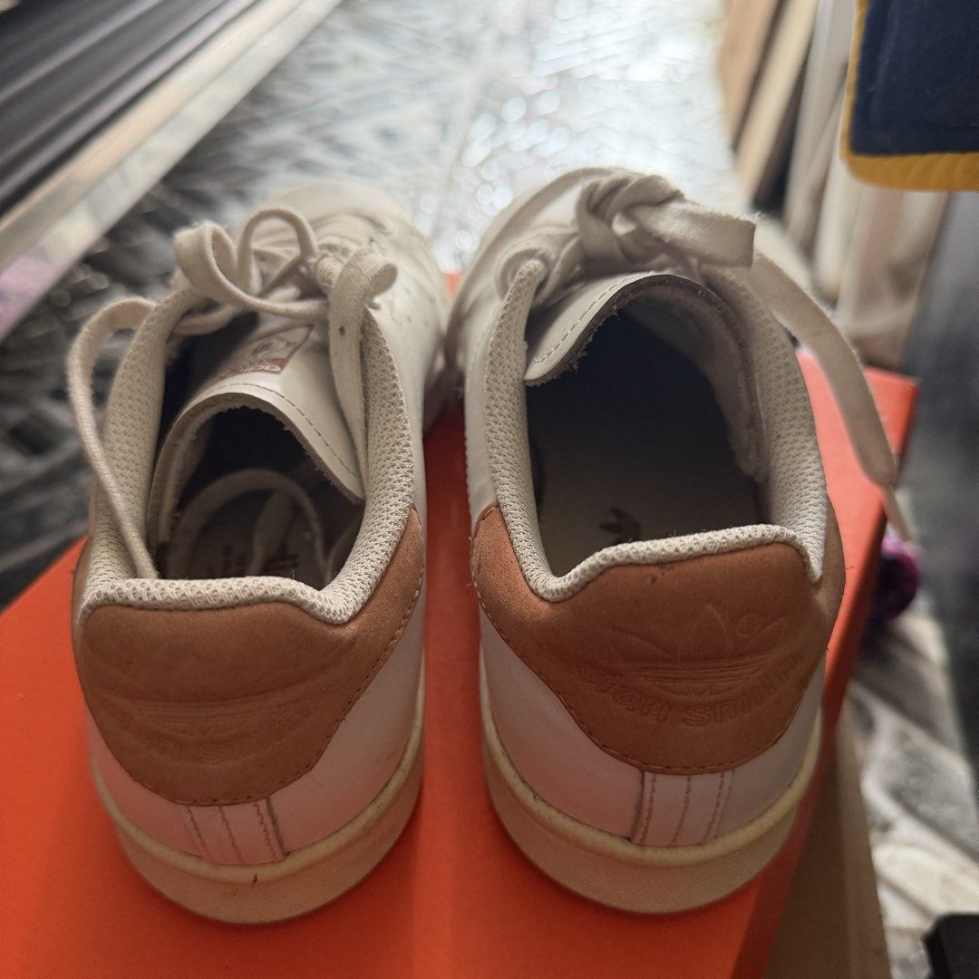 Adidas Stan Smith White Tan Sneakers (Category: Sneakers) located in Manila. Submitted by basiliocla11530 (Listing ID 1466011748, Image 2). Description: - Brand: Adidas Stan Smith - Color: White leather with tan suede heel tabs - Features: Perforated three stripes, signature tongue portrait tag, and embossed trefoil logo - Condition: Great everyday casual shoes with minor wear on soles from normal use - Inclusions: White laces and matching inner 