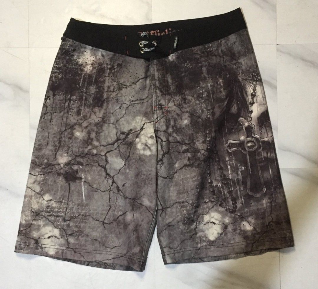 Affliction Graphic Cross Board Shorts (Category: Swim Trunks & Board Shorts) located in Imus. Submitted by thrifts_select (Listing ID 1465996843, Image 3). Description: - Brand: Affliction - Color: Black and grey - Design: Bold cross graphic with cracked stone texture and fleur-de-lis back patch - Closure: Front lace-up with branded metal eyelets - Details: Signature Affliction embroidery on inner and outer waistband - Condition: Great quality, p